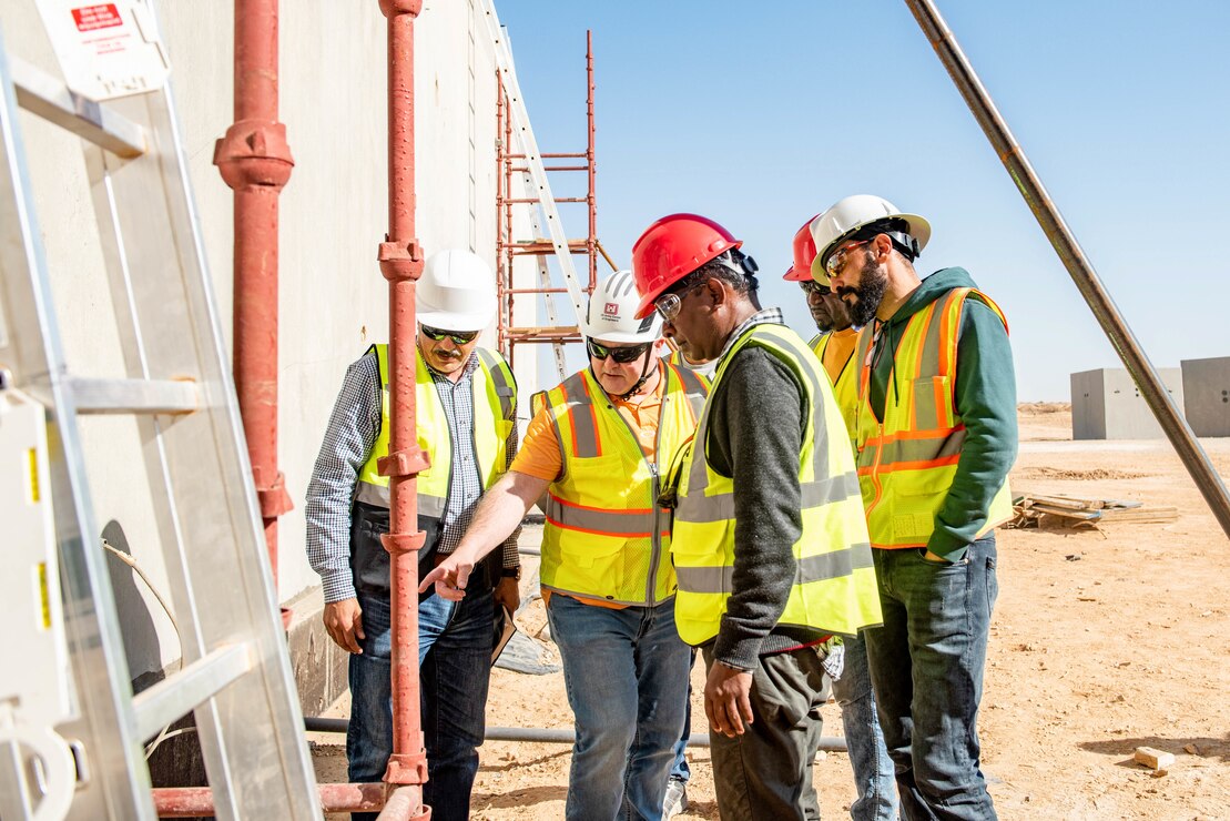 A group of men inspecting a construction site.