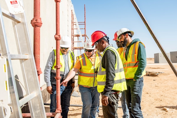 A group of men inspecting a construction site.
