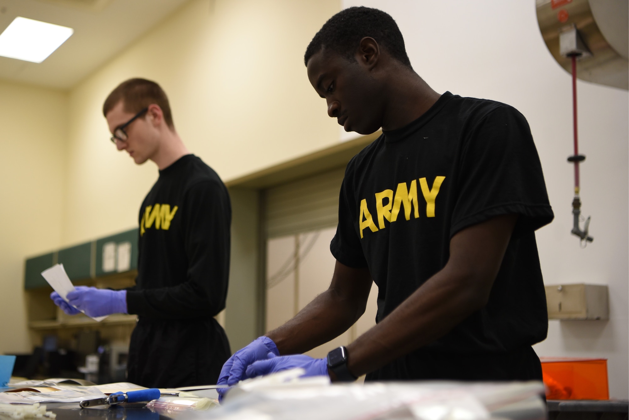 U.S. Army Mortuary Affairs Specialists Spc. Noah Hughes and Sgt. Marquil Marshburn, catalogue remains found during Operation Colony Glacier, July 10, 2023, at Dover Air Force Base, Del. The remains are stored until ready for DNA identification attempts by the Armed Forces DNA Identification Laboratory. (U.S. Air Force photo by Staff Sgt. Deven Schultz)