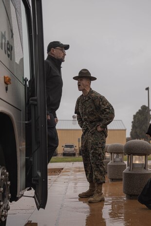 U.S. Marine Corps Staff Sgt. Asen Poole, a native of Choudrant, Louisiana, and a drill instructor with Support Battalion, Recruit Training Regiment, directs members of the Executive Leadership Development Program to the yellow footprints during a mock receiving event at Marine Corps Recruit Depot San Diego, California, Feb. 6, 2024. The purpose of the visit is to familiarize participants of the ELDP with the rigors or recruit training and highlight the uniqueness that distinguishes Marines from the other branches of the Armed Forces. (U.S. Marine Corps photo by Lance Cpl. Alexandra M. Earl)
