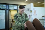 Lcdr. Laura Riebel helps a patient stretch during a physical therapy session. Riebel was awarded the Navy Medicine Senior Physical Therapy Officer of the Year for 2023