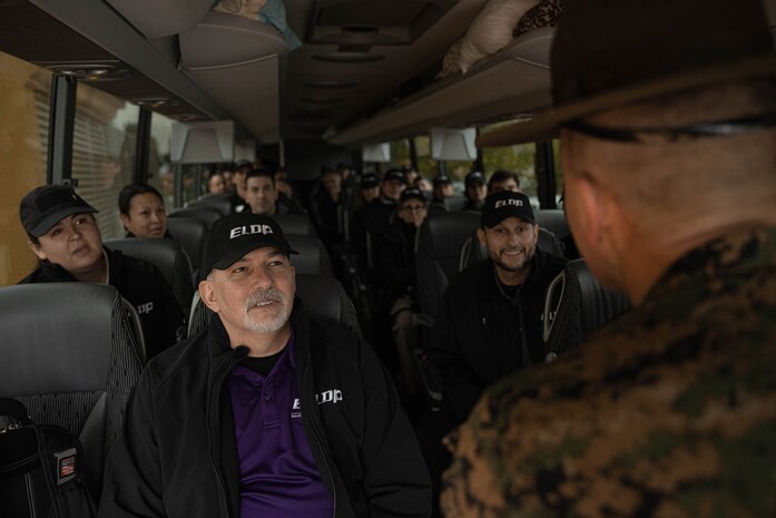 Members of the Executive Leadership Development Program, wait to exit a bus during a mock receiving event at Marine Corps Recruit Depot San Diego, California, Feb. 6, 2024. The purpose of the visit is to familiarize participants of the ELDP with the rigors or recruit training and highlight the uniqueness that distinguishes Marines from the other branches of the Armed Forces. (U.S. Marine Corps photo by Lance Cpl. Alexandra M. Earl)