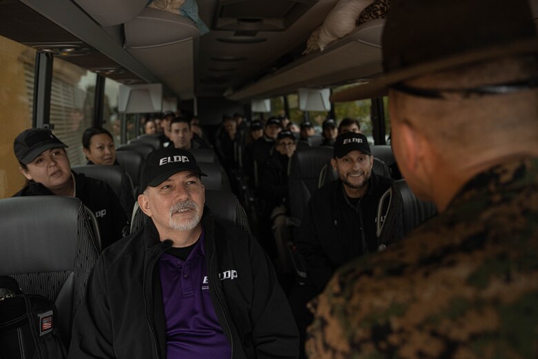 Members of the Executive Leadership Development Program, wait to exit a bus during a mock receiving event at Marine Corps Recruit Depot San Diego, California, Feb. 6, 2024. The purpose of the visit is to familiarize participants of the ELDP with the rigors or recruit training and highlight the uniqueness that distinguishes Marines from the other branches of the Armed Forces. (U.S. Marine Corps photo by Lance Cpl. Alexandra M. Earl)