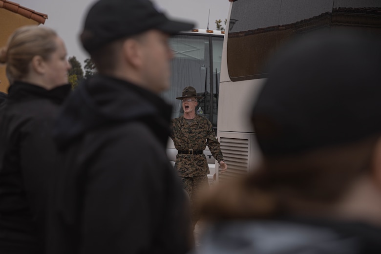 U.S. Marine Corps Sgt. Davis Wheat, a native of Fort Collins, Colorado, and a senior drill instructor with Support Battalion, Recruit Training Regiment, directs members of the Executive Leadership Development Program on the yellow footprints during a mock receiving event at Marine Corps Recruit Depot San Diego, California, Feb. 6, 2024. The purpose of the visit is to familiarize participants of the ELDP with the rigors or recruit training and highlight the uniqueness that distinguishes Marines from the other branches of the Armed Forces. (U.S. Marine Corps photo by Lance Cpl. Alexandra M. Earl)