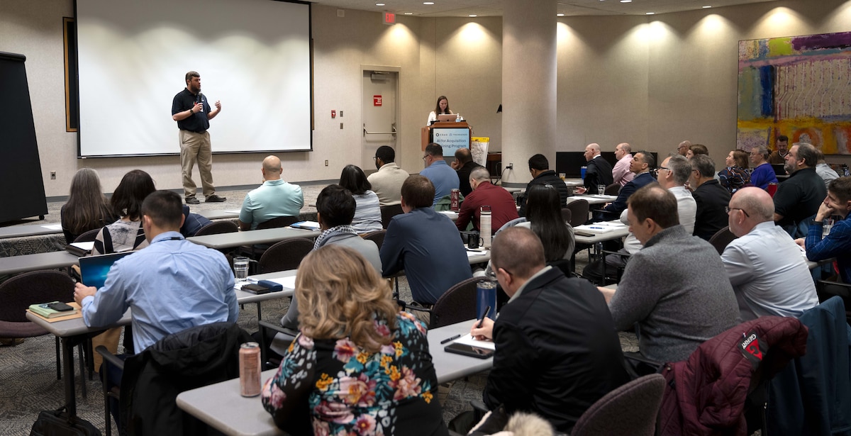 An AI instructor gives opening remarks prior to a training event.