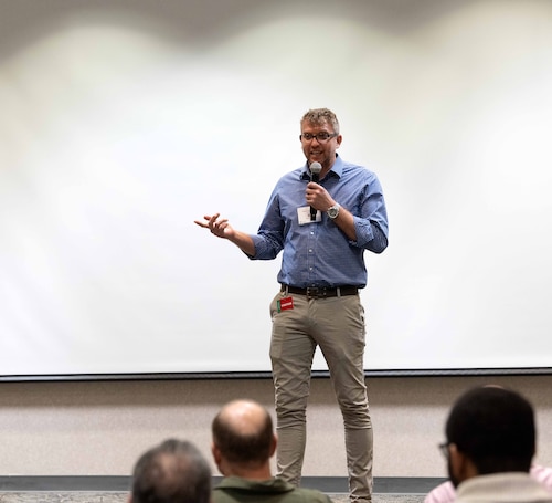 A facilitator gives AI training.