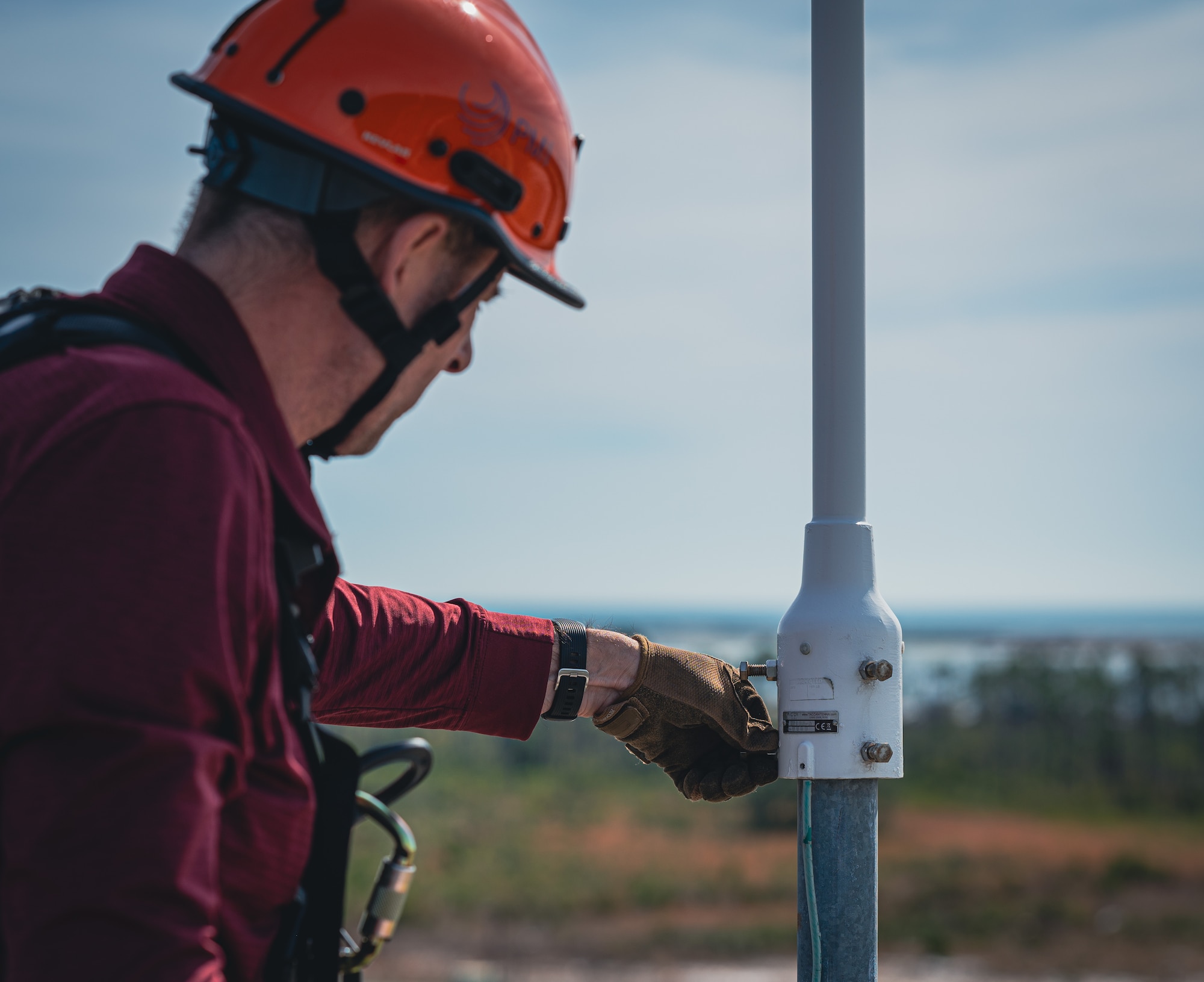 Civilian installs a bolt on radio tower