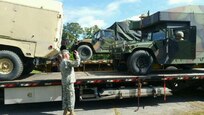 Soldiers from Danville-based 429th Brigade Support Battalion, 116th Infantry Brigade Combat Team load equipment onto flatbed trucks to be transported to Fort Drum for annual training.