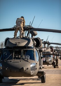 Soldiers with Charlie Company, 1st Battalion (Assault Helicopter Battalion), 244th Aviation Regiment, 90th Troop Command, Oklahoma Army National Guard perform maintenance on a UH-60 Black Hawk at Fort Cavazos, Texas, Jan. 9, 2024. The 244th AHB underwent rigorous pre-mobilization training in preparation for their upcoming deployment to Kosovo in support of Operation Joint Guardian. (Oklahoma National Guard photo by Cpl. Danielle Rayon)