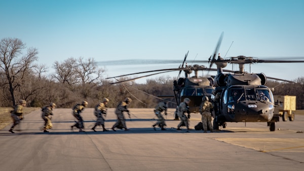 Soldiers with the 48th Infantry Brigade Combat Team, Georgia National Guard and 1st Battalion (Assault Helicopter Battalion), 244th Aviation Regiment, 90th Troop Command, Oklahoma Army National Guard conduct hot load training with a UH-60 Black Hawk helicopter at Fort Cavazos, Texas, Jan. 9, 2024. The 244th AHB underwent rigorous pre-mobilization training in preparation for their upcoming deployment to Kosovo in support of Operation Joint Guardian. (Oklahoma National Guard photo by Cpl. Danielle Rayon)