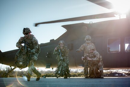 Soldiers with the 48th Infantry Brigade Combat Team, Georgia Army National Guard and 1st Battalion (Assault Helicopter Battalion), 244th Aviation Regiment, 90th Troop Command, Oklahoma Army National Guard conduct hot load training with a UH-60 Black Hawk helicopter at Fort Cavazos, Texas, Jan. 9, 2024. The 244th AHB underwent rigorous pre-mobilization training in preparation for their upcoming deployment to Kosovo in support of Operation Joint Guardian. (Oklahoma National Guard photo by Cpl. Danielle Rayon)