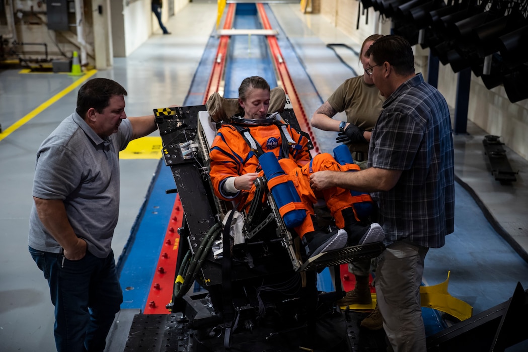 An Air Force Research Laboratory, or AFRL, team and NASA prepare a U.S. Air Force volunteer on the horizontal sled test facility at Wright-Patterson Air Force Base, Ohio, Oct. 23, 2023, to test the next replica of a seat and flight suit for the Orion space capsule. Researchers with the AFRL Human Effectiveness Directorate tested equipment for the Orion space capsule’s upcoming mission to the moon. (U.S. Air Force photo / Richard Eldridge)