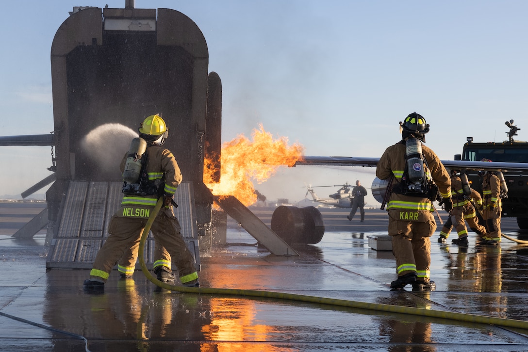 U.S. Marines with Aircraft Rescue and Fire Fighting (ARFF), Headquarters and Headquarters Squadron, Marine Corps Air Station Yuma, Arizona, extinguishes simulated aircraft fire at the installation, Dec. 15, 2023. ARFF performs routine training that equips Marines with the necessary skills and knowledge to efficiently respond to emergencies. (U.S. Marine Corps photo by Lance Cpl. Elizabeth Gallagher)