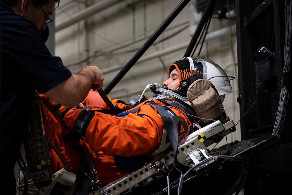 A U.S. Air Force volunteer, who tests the next replica of a flight suit and seat for the Orion space capsule, is strapped into the seat in the drop tower facility at Wright-Patterson Air Force Base, Ohio, Nov. 3, 2023. Researchers with the Air Force Research Laboratory’s Human Effectiveness Directorate tested equipment along with NASA for the Orion space capsule’s upcoming mission to the moon. (U.S. Air Force photo / Richard Eldridge)