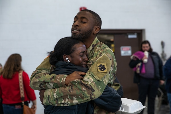 Loved ones gather alongside nearly 50 Oklahoma Army National Guardsmen during a deployment ceremony held Saturday, Dec. 30, 2023, at the Army Aviation Support Facility 2 in Tulsa, Oklahoma. Members of Charlie Company, 1st Battalion (Assault Helicopter Battalion), 244th Aviation Regiment, 90th Troop Command, will deploy overseas to Kosovo in support of Operation Joint Guardian (KFOR). KFOR is a NATO-led international peacekeeping force in Kosovo that is comprised of 27 partner nations. (Oklahoma National Guard photo by Staff Sgt. Reece Heck)