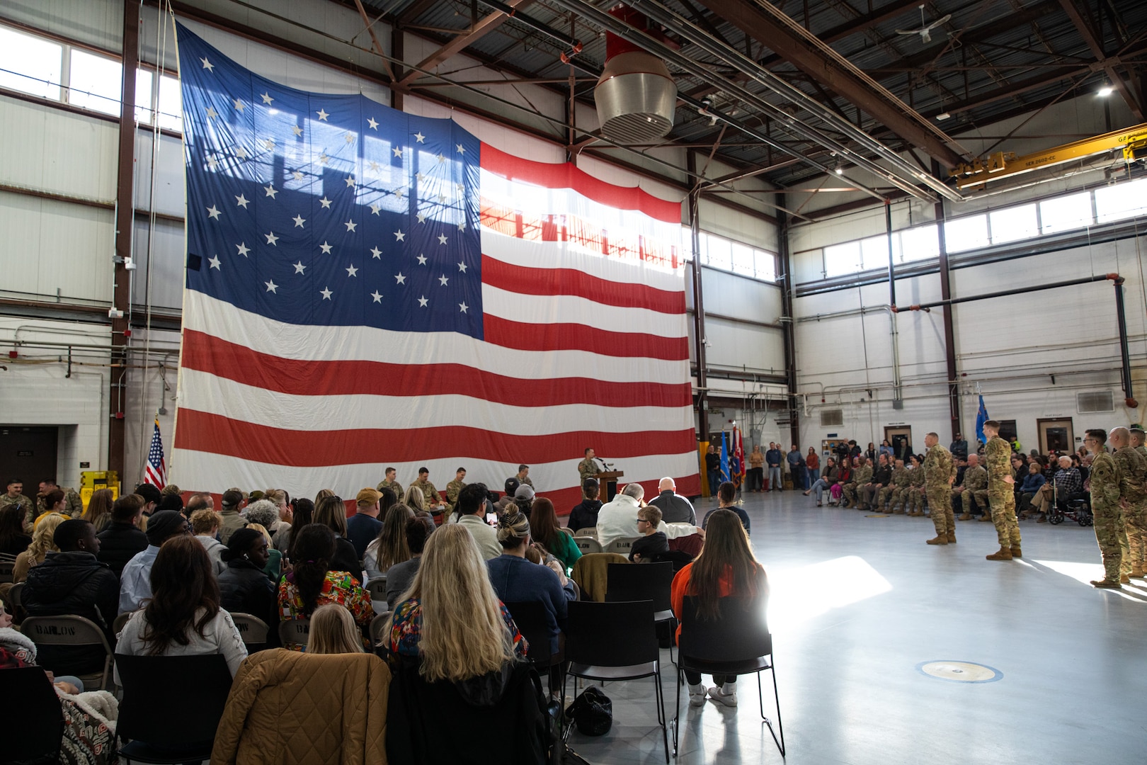 Loved ones gather alongside nearly 50 Oklahoma Army National Guardsmen during a deployment ceremony held Saturday, Dec. 30, 2023, at the Army Aviation Support Facility 2 in Tulsa, Oklahoma. Members of Charlie Company, 1st Battalion (Assault Helicopter Battalion), 244th Aviation Regiment, 90th Troop Command, will deploy overseas to Kosovo in support of Operation Joint Guardian (KFOR). KFOR is a NATO-led international peacekeeping force in Kosovo that is comprised of 27 partner nations. (Oklahoma National Guard photo by Staff Sgt. Reece Heck)