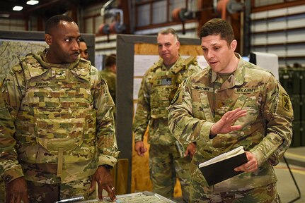 U.S. Army Brig. Gen. David Jenkins, left, assistant adjutant general, South Carolina National Guard, and U.S. Army Command Sgt. Maj. Richard Kyzer II, South Carolina Army National Guard State Command sergeant major, visit Soldiers with the 218th Maneuver Enhancement Brigade during a joint Warfighter exercise with Soldiers assigned to the 10th Mountain Division, Fort Drum, New York, June 11, 2022.