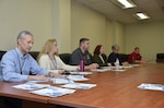 group of people discuss at table