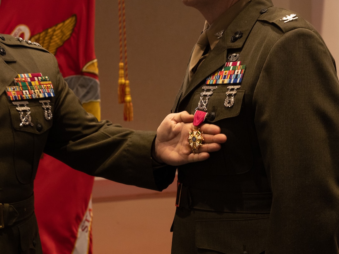 U.S. Marine Corps Lt. Gen. David Bellon, commander of Marine Forces Reserve and Marine Forces South, brings attention to the newly pinned Legion of Merit medal on Col. Daniel Sullivan during his retirement ceremony at Marine Barracks Washington, D.C, Feb. 1, 2024. During the ceremony, Sullivan was honored for his time in the Marine Corps and congratulated for his 30 years of service. Sullivan is a U.S. Senator from Alaska and pursued a career in the Marine Corps Reserve simultaneously. (U.S. Marine Corps photo by Lance Cpl. Sarah Pysher)