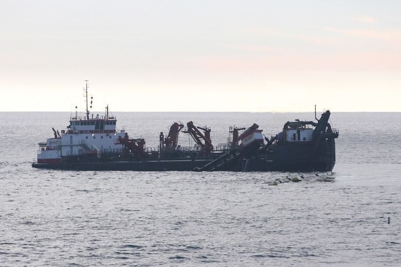A split-hull trailing suction hopper dredge, called the Bayport, operates Jan. 31 off the shore of Solana Beach, California.
