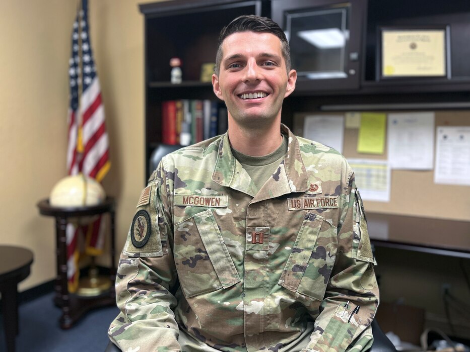 An Air Force officer in uniform smiles at the camera.