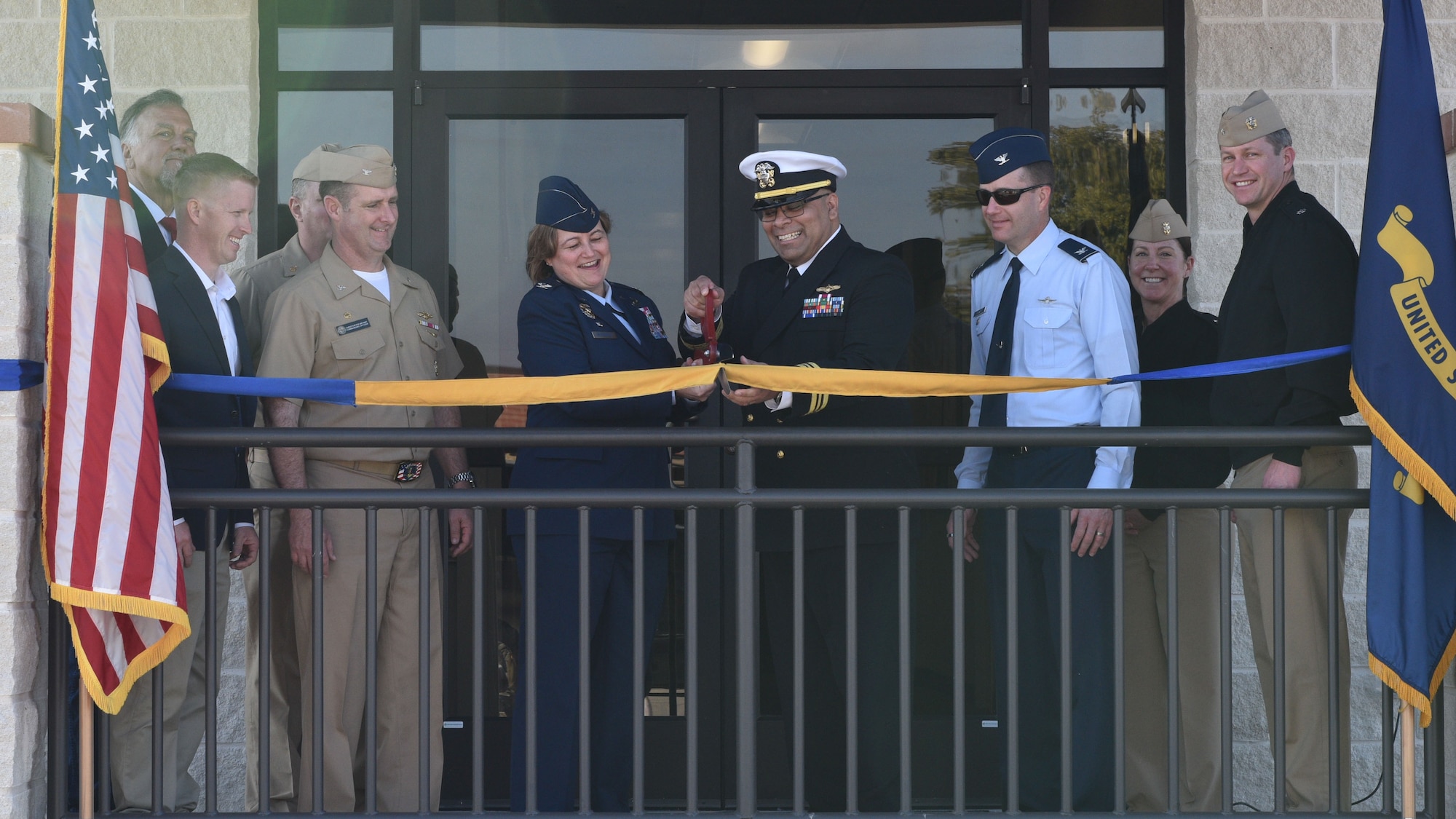 U.S. Air Force Col. Angelina Maguinness, 17th Training Wing commander, and U.S. Navy Lt. Cmdr. Nicholas Leyba Center for Information Warfare Training Command Monterey, Detachment Goodfellow Headquarters commander, cut the ribbon at the Navy Ribbon Cutting Ceremony at Goodfellow Air Force Base Feb. 2, 2024. This project signifies the completion of the newest building on base and the start of a more extensive update to Goodfellow’s infrastructure. (U.S. Air Force photo by 2nd Lt. Kayunna Holt)