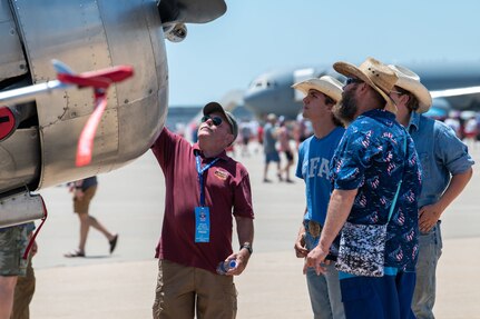 Retired Col. Robert Prater, a former 137th Special Operations Wing Guardsman, shows air show attendees his T-6G Texan aircraft at the Tinker Air Show on July 1, 2023, at Tinker Air Force Base, Oklahoma City. Prater has been flying World War II-style aircraft for over 20 years to share military history with future generations. (U.S. Air National Guard photo by Airman 1st Class Erika Chapa)