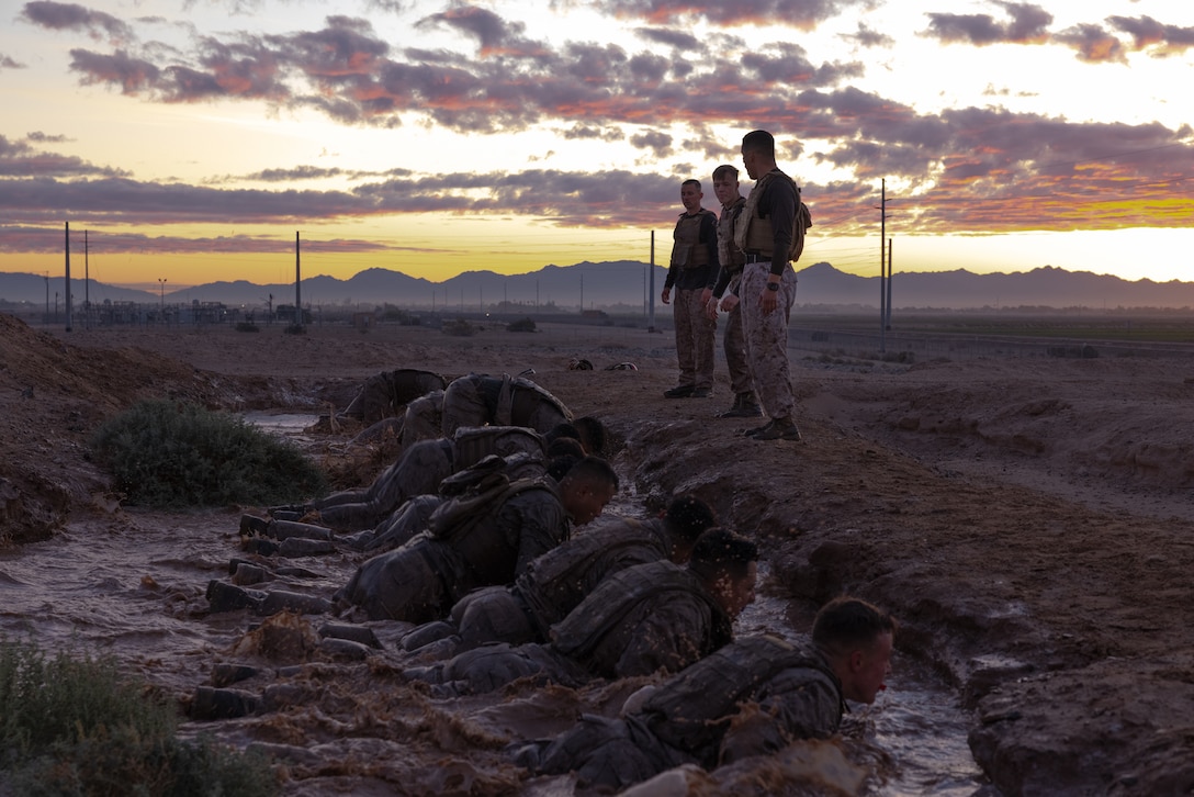 U.S. Marines from various units stationed on Marine Corps Air Station Yuma, Arizona, participate in physical training during a Martial Arts Instructor course at Marine Corps Air Station Yuma, Arizona, Dec. 21, 2023. This three week course consisted of many hours of physical training, hand-to-hand combat, grappling, weapons sparring training and memorizing the Marine Corps Martial Arts Program syllabus with the intent to certify Marines to instruct and monitor the various belts levels within the Marine Corps Martial Arts Program. (U.S. Marine Corps photo by Lance Cpl. Elizabeth Gallagher)