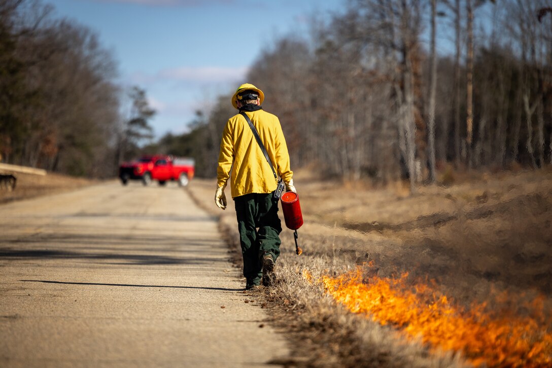 Brehm Corbin, a firefighter with Quantico Fire and Emergency Services, conducts a controlled burn on Marine Corps Base Quantico, Virginia, Feb. 6, 2024. The purpose of the burns is to reduce fuel litter, minimize the potential of wildfires, and promote wildlife habitat. (U.S. Marine Corps photo by Lance Cpl. Joaquin Dela Torre)