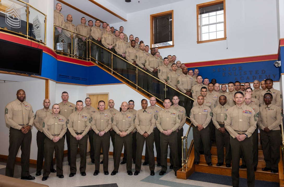 Sergeant Major of the Marine Corps Sgt. Maj. Carlos A. Ruiz, a Sonora, Mexico native, poses for a group photo with the Marines of First Sergeant School Class 1-24 on Marine Corps Base Quantico, Virginia, Feb. 9, 2024. The course is designed to rigorously prepare first sergeants for their role in leading future generations of Marines. (U.S. Marine Corps photo by Sgt. Mitchell Johnson)