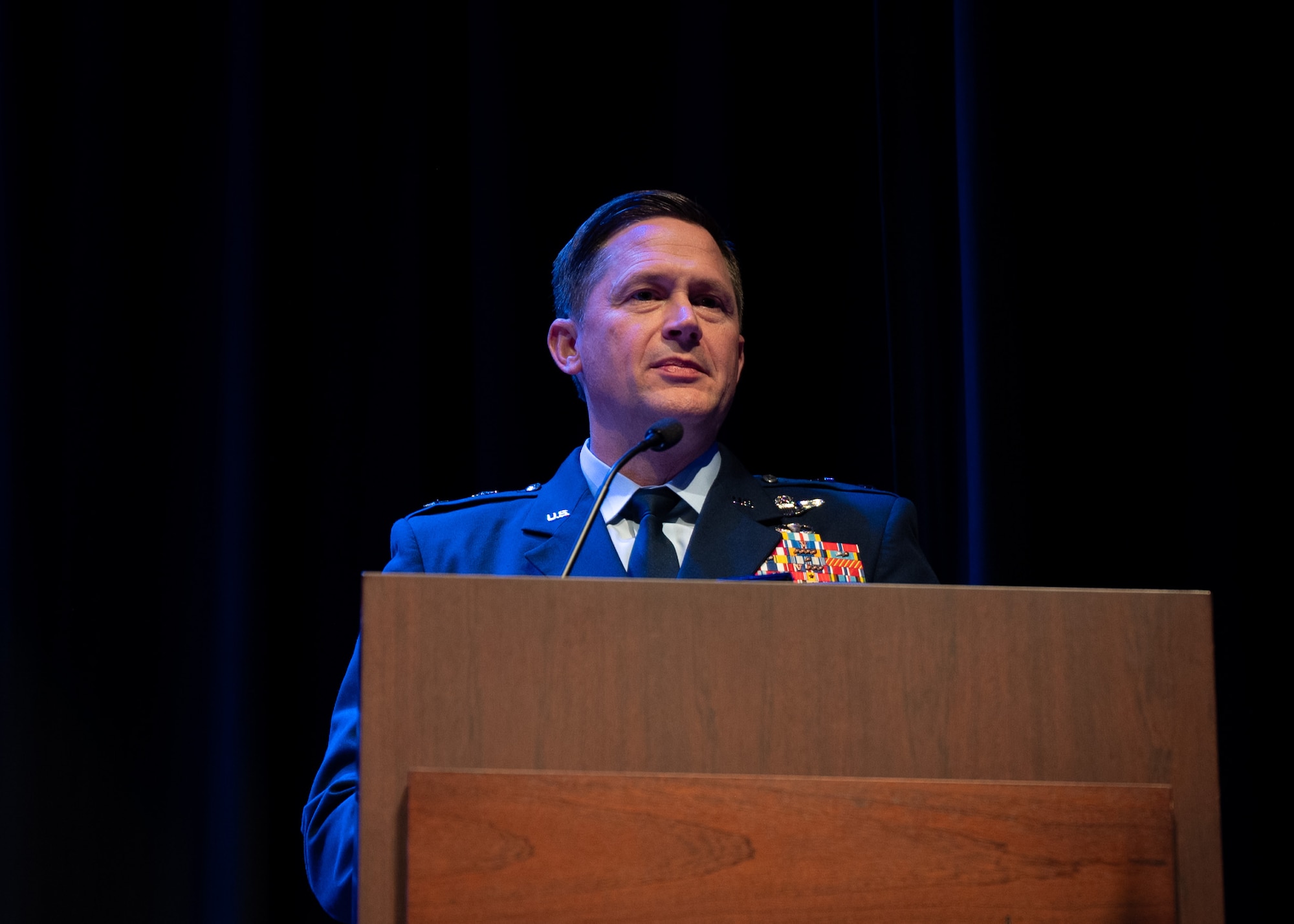 Airman speaks behind a podium
