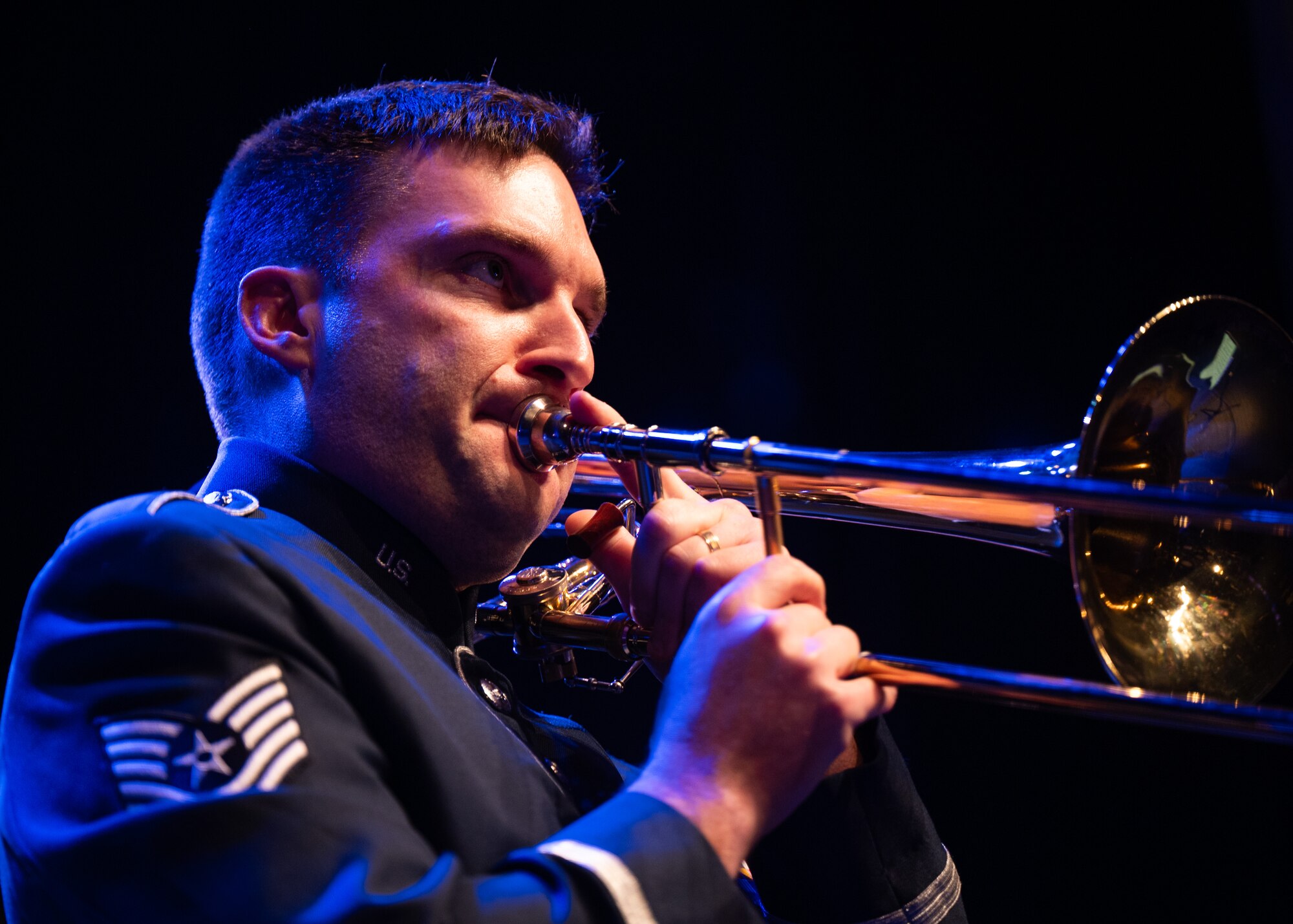 Airman plays trombone on stage