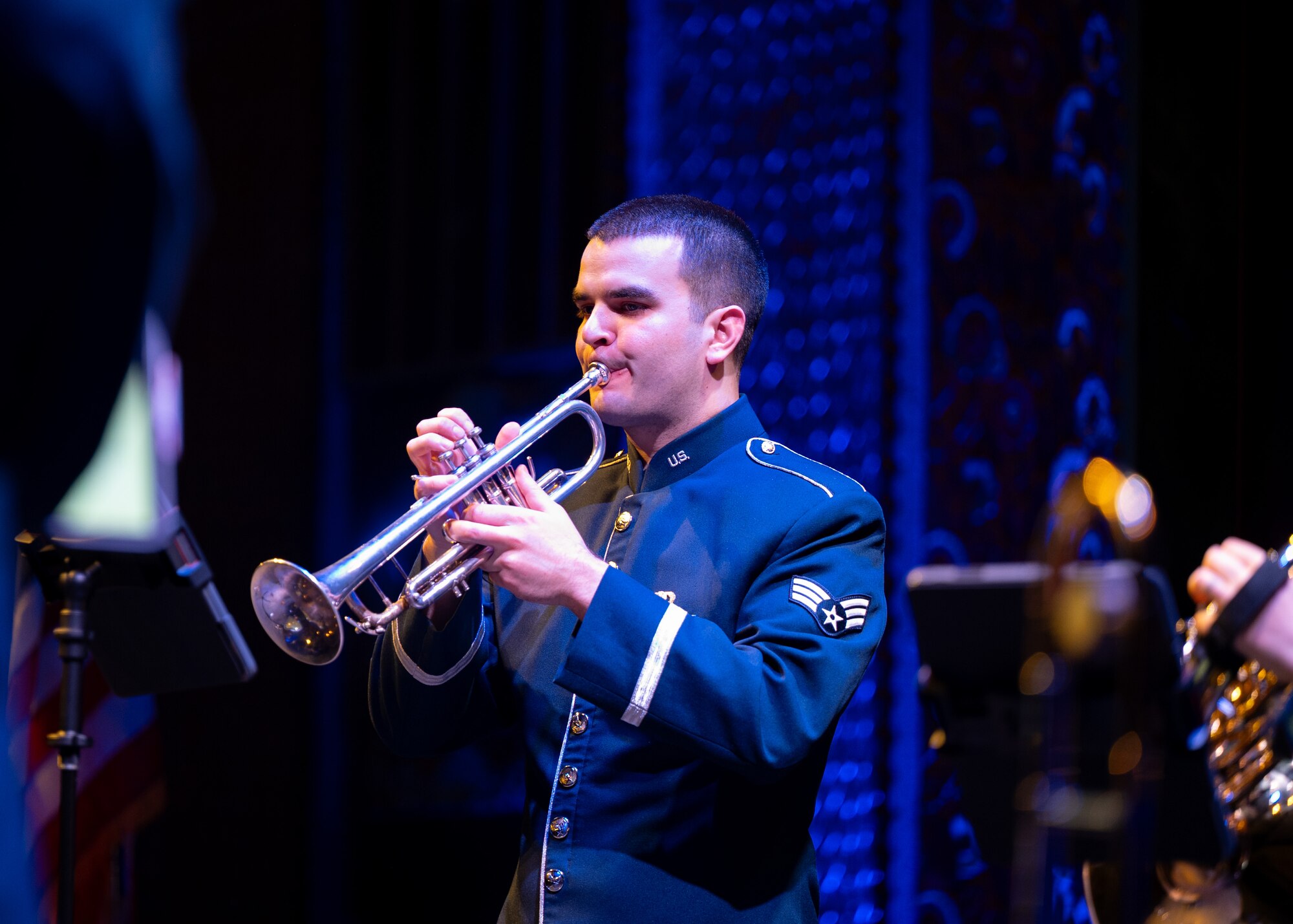 Airman plays trumpet on stage