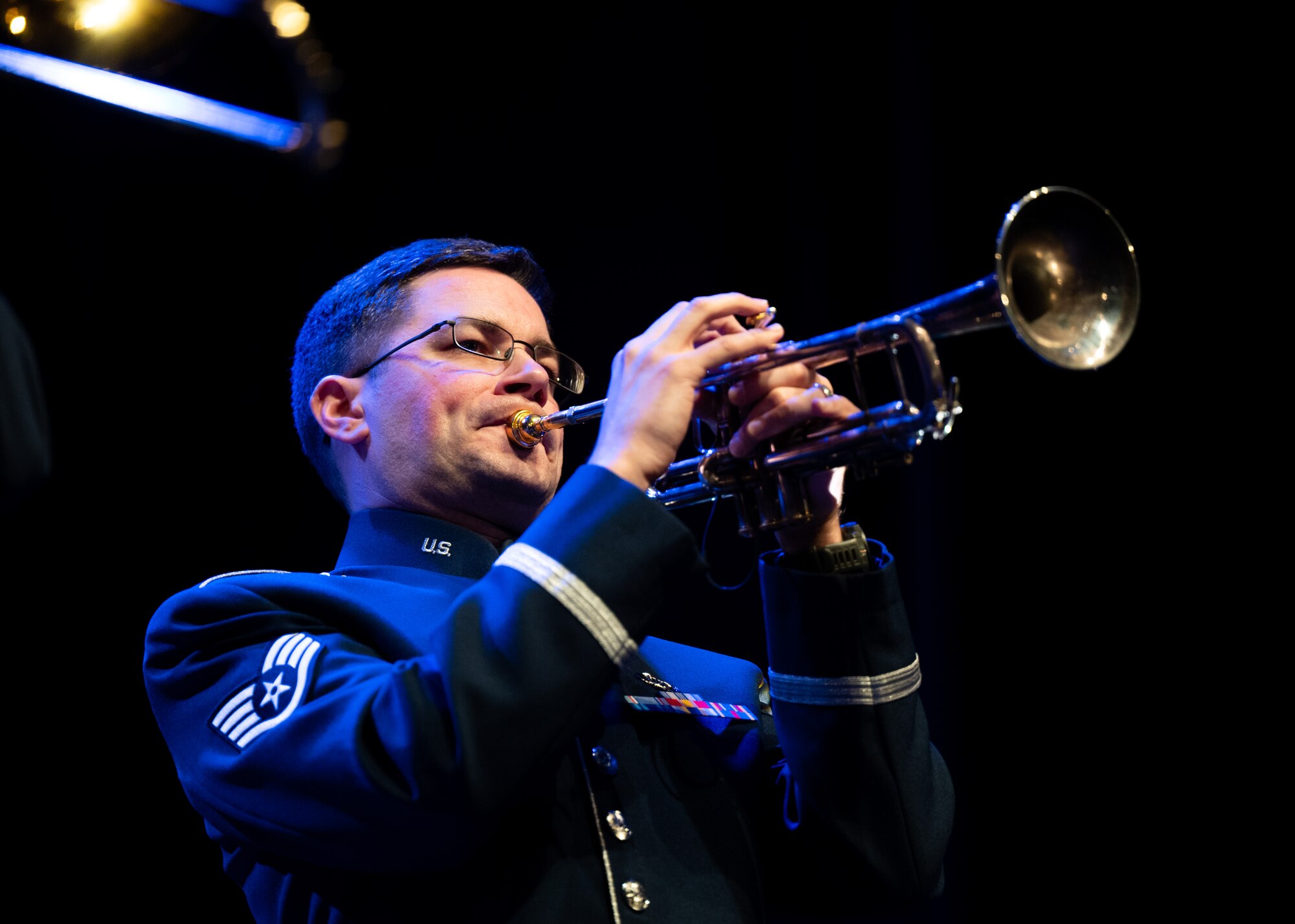 Airman plays trumpet on stage