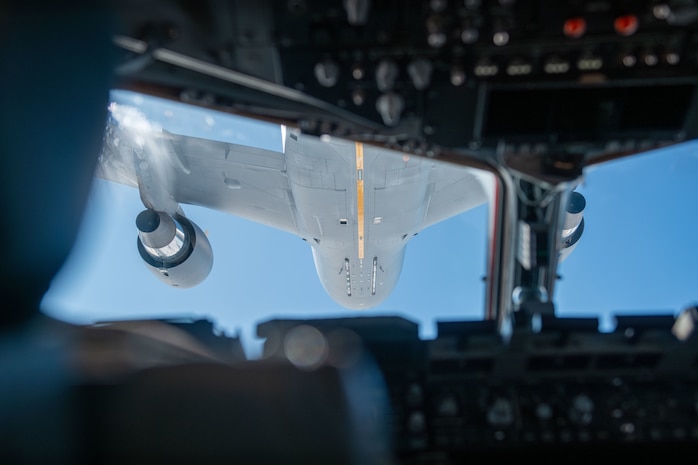 A plane refuels another plane.