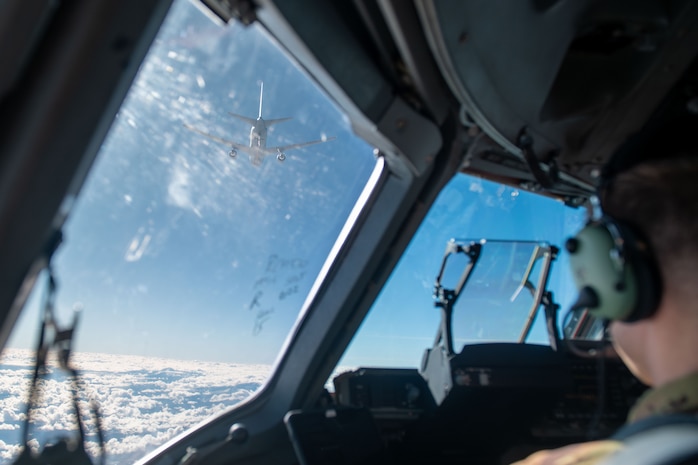 A plane refuels another plane.