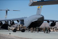 U.S. Marines load cargo into a plane.