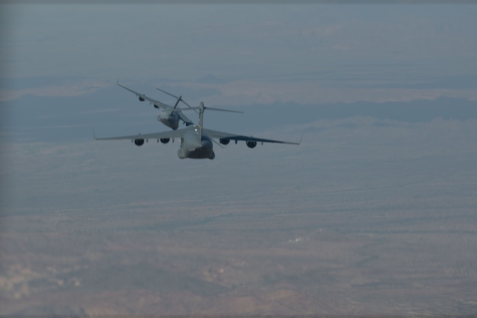 Two planes fly in the sky.
