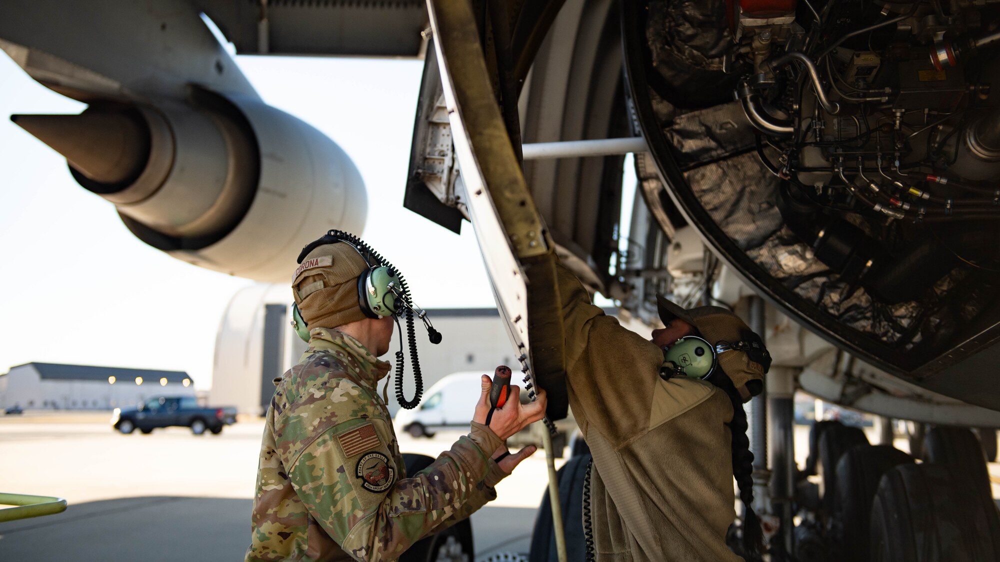 U.S. Air Force Airman 1st Class Pablo Corona and Brenda Gonzalez Galvez, 436th Aircraft Maintenance Squadron crew chiefs, close a panel on a C-5M Super Galaxy at Dover Air Force Base, Delaware, Feb. 7, 2024. The C-5M Super Galaxy was delivered to Westover Air Reserve Base, Massachusetts for an isochronal maintenance inspection. (U.S. Air Force photo by Tech. Sgt. J.D. Strong II)