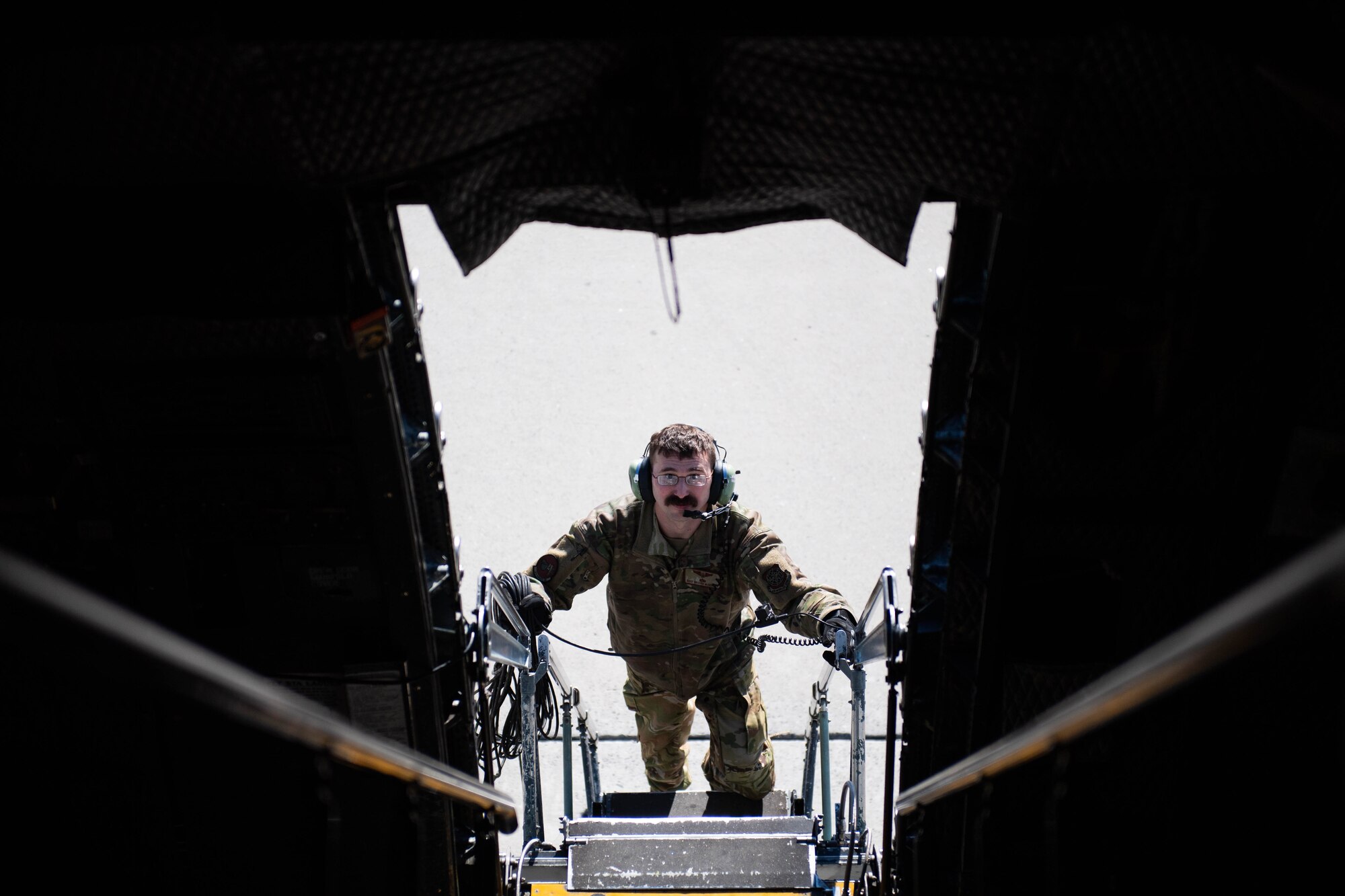 U.S. Air Force Staff Sgt. Broden McDonald, 9th Airlift Squadron flight engineer, climbs the stairs of a C-5M Super Galaxy at Dover Air Force Base, Delaware, Feb. 7, 2024. The C-5M Super Galaxy was delivered to Westover Air Reserve Base, Massachusetts for an isochronal maintenance inspection. (U.S. Air Force photo by Tech. Sgt. J.D. Strong II)
