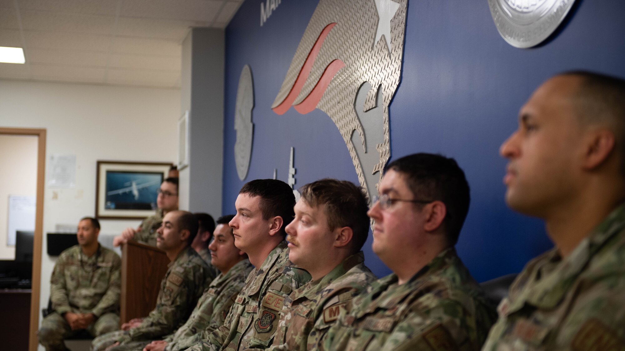 Airmen assigned to the 436th Maintenance Squadron, Operating Location Alpha, listen at an all-call at Westover Air Reserve Base, Massachusetts, Feb. 7, 2024. During the visit, 436th Airlift Wing leadership toured the C-5M Isochronal Maintenance Dock and conducted an all-call to members of the 436th Maintenance Squadron, Operating Location Alpha, a tenant unit of the 436th AW. (U.S. Air Force photo by Tech. Sgt. J.D. Strong II)