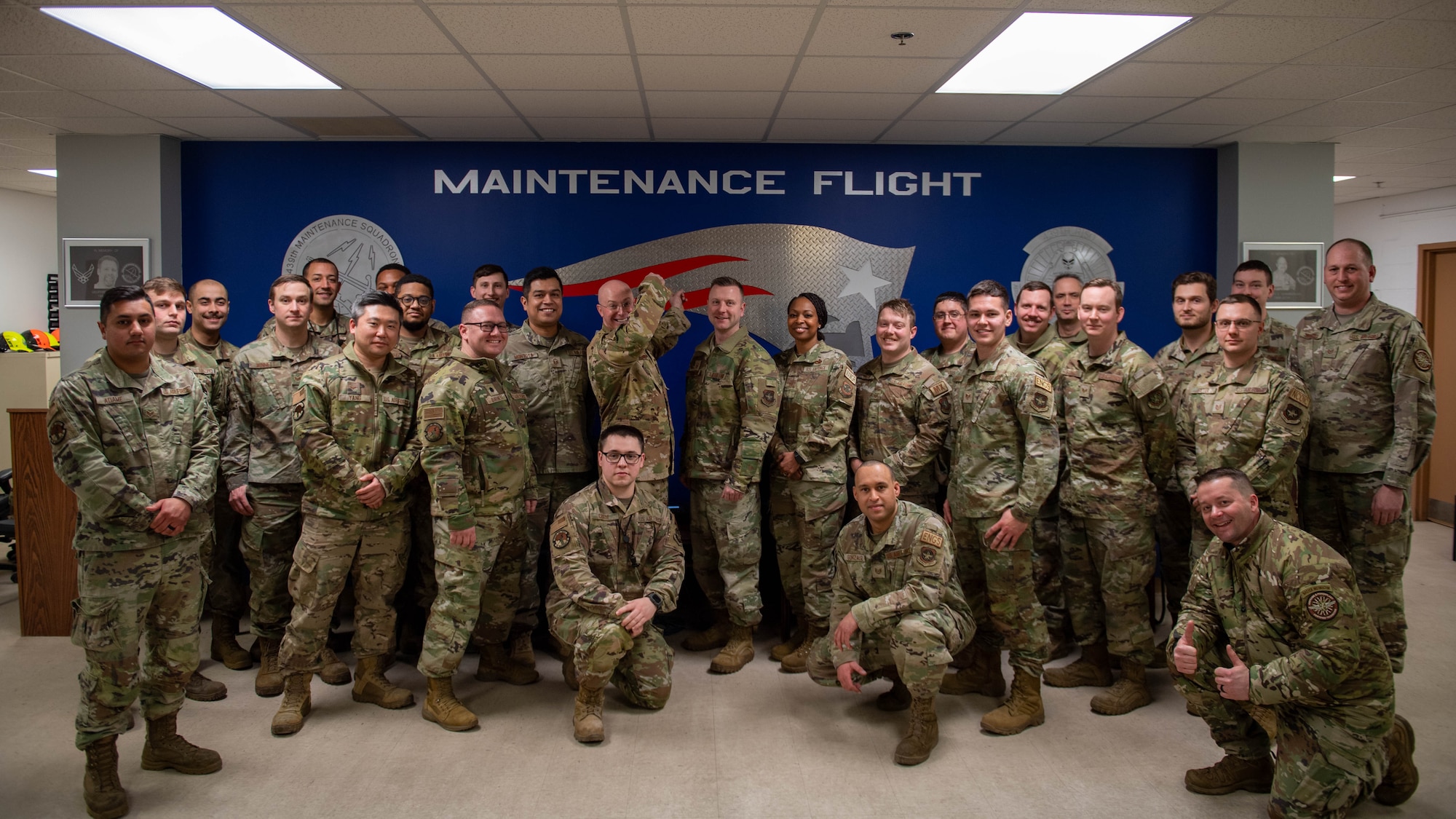 436th Airlift Wing senior leaders and Airmen assigned to the 436th Maintenance Squadron, Operating Location Alpha, pose for a photo at Westover Air Reserve Base, Massachusetts, Feb. 7, 2024. During the visit, 436th Airlift Wing leadership toured the C-5M Isochronal Maintenance Dock and conducted an all-call to members of the 436th Maintenance Squadron, Operating Location Alpha, a tenant unit of the 436th AW. (U.S. Air Force photo by Tech. Sgt. J.D. Strong II)