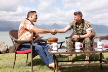 U.S. Marine Corps Col. Jeremy Beaven, right, commanding officer, Marine Corps Base Hawaii, shakes hands with Kamaka Pili, left, host of "Aloha Authentic", after filming a news segment at MCBH, Hawaii, Jan. 22, 2024. The news segment covered discussion of topics including base access, natural resource use, and community concerns in an effort to spark dialogue between base leadership and community members. (U.S. Marine Corps photo by Sgt. Brandon Aultman)