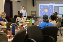 Sam Whitin, the director of Coastal Resilience at EA Engineering, Science, and Technology, discusses ways to increase the resilience of Marine Corps resources using nature-based solutions during a meeting with members representing Marstel-Day, Jacobs, Environmental Compliance and Protection Division, and Marine Corps Base Hawaii staff through the Engineering with Nature program at MCBH, Jan. 30, 2024. The main efforts of the project will be to improve coastal resilience while maintaining beach training abilities at Marine Corps Training Area Bellows and Pu’uloa Range Training Facility. (U.S. Marine Corps photo by Sgt. Julian Elliott-Drouin)