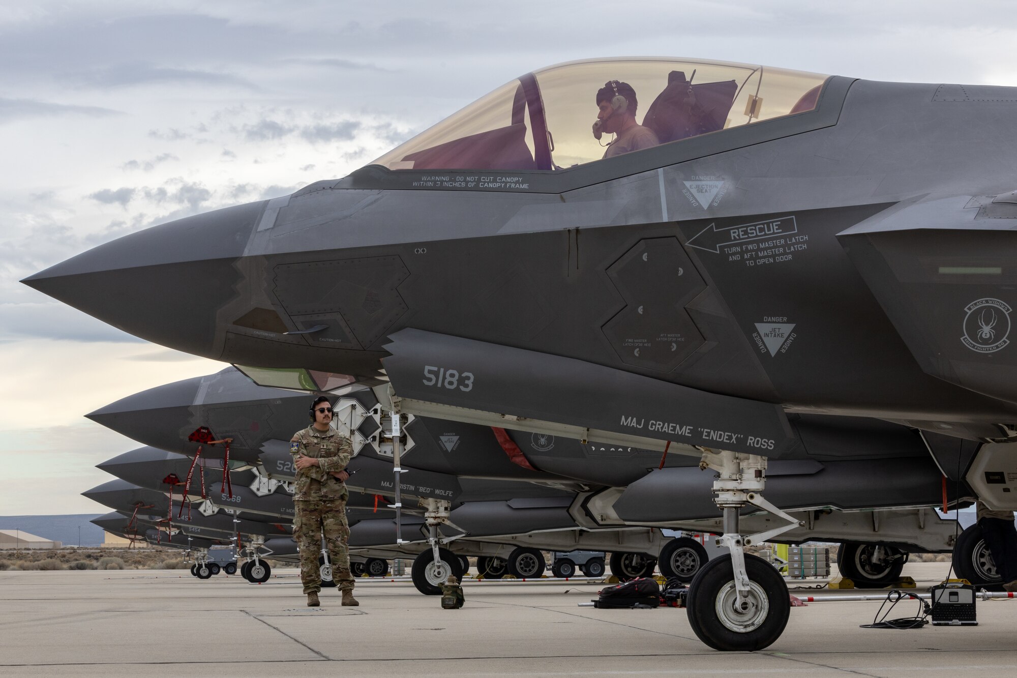 A photo of an F-35 maintainer performing an engine run in the cockpit