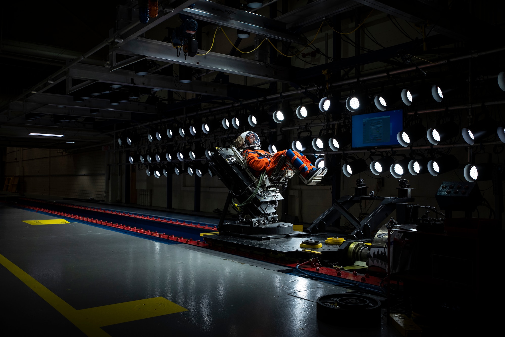 A U.S. Air Force volunteer with the Biodynamics Laboratory tests the next replica of a seat and flight suit for the Orion space capsule and NASA on the horizontal sled test facility at Wright-Patterson Air Force Base, Ohio, Oct. 23, 2023. Researchers with the Air Force Research Laboratory Human Effectiveness Directorate tested equipment for the Orion space capsule’s upcoming mission to the moon. (U.S. Air Force photo / Richard Eldridge)