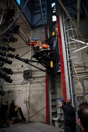 A U.S. Air Force volunteer tests the next replica of a flight suit and seat for the Orion space capsule in the drop tower facility at Wright-Patterson Air Force Base, Ohio, Nov. 3, 2023. Researchers with the Air Force Research Laboratory’s Human Effectiveness Directorate tested equipment along with NASA for the Orion space capsule’s upcoming mission to the moon. (U.S. Air Force photo / Richard Eldridge)