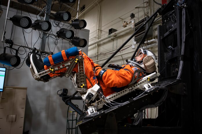 A U.S. Air Force volunteer tests the next replica of a flight suit and seat for the Orion space capsule in the drop tower facility at Wright-Patterson Air Force Base, Ohio, Nov. 3, 2023. Researchers with the Air Force Research Laboratory’s Human Effectiveness Directorate tested equipment along with NASA for the Orion space capsule’s upcoming mission to the moon. (U.S. Air Force photo / Richard Eldridge)