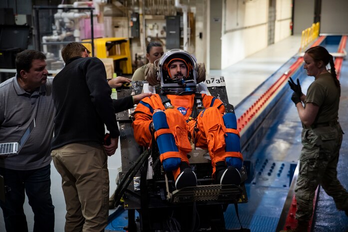 An Air Force Research Laboratory, or AFRL, team works with NASA and a U.S. Air Force volunteer on the horizontal sled test facility at Wright-Patterson Air Force Base, Ohio, Oct. 23, 2023, to test the next replica of a seat and flight suit for the Orion space capsule. Researchers with the AFRL Human Effectiveness Directorate tested equipment for the Orion space capsule’s upcoming mission to the moon. (U.S. Air Force photo / Richard Eldridge)