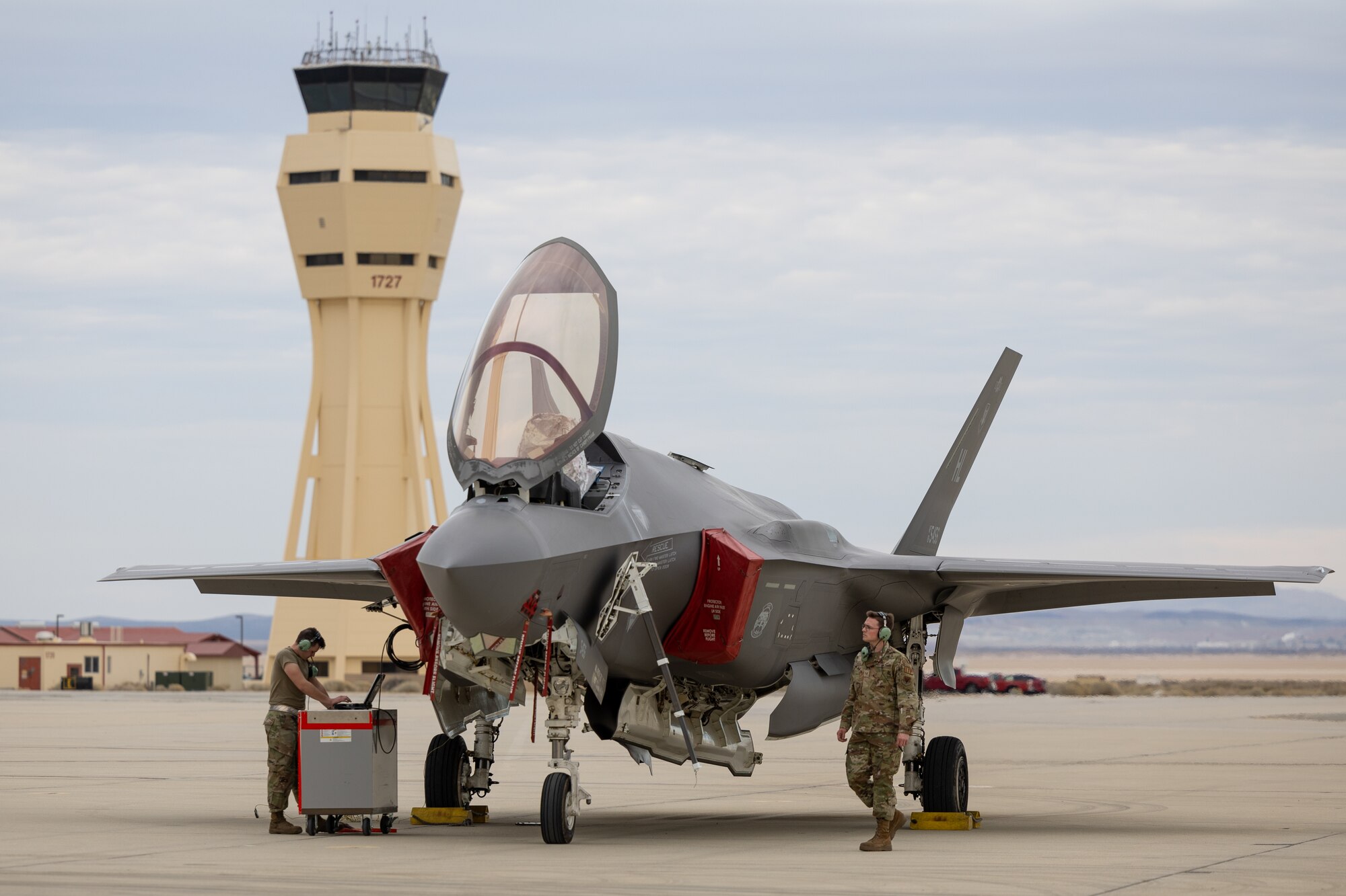 a photo of a group of F-35 maintainers working around an aircraft on the flightline